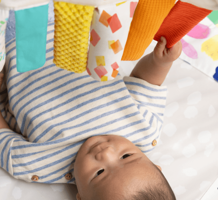 Sensory Strands hanging on The Play Gym by Lovevery